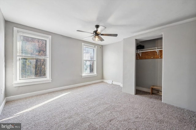 unfurnished bedroom featuring ceiling fan, a closet, and carpet