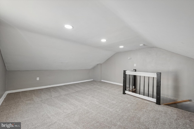 additional living space featuring lofted ceiling and carpet floors