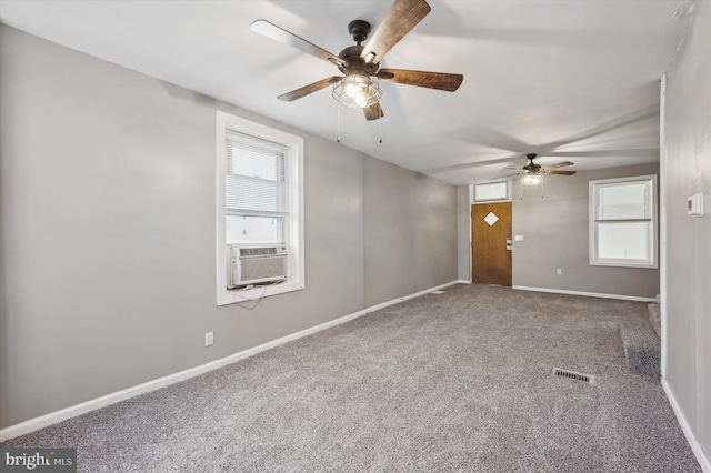 carpeted empty room featuring cooling unit and ceiling fan