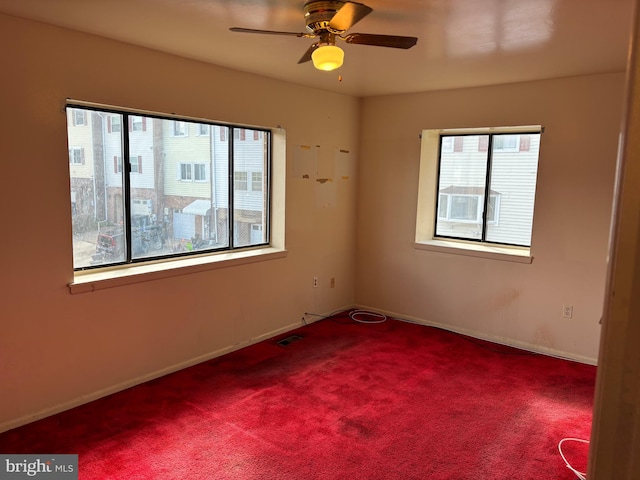 unfurnished room with carpet flooring and ceiling fan