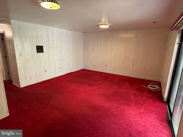 unfurnished room featuring dark colored carpet