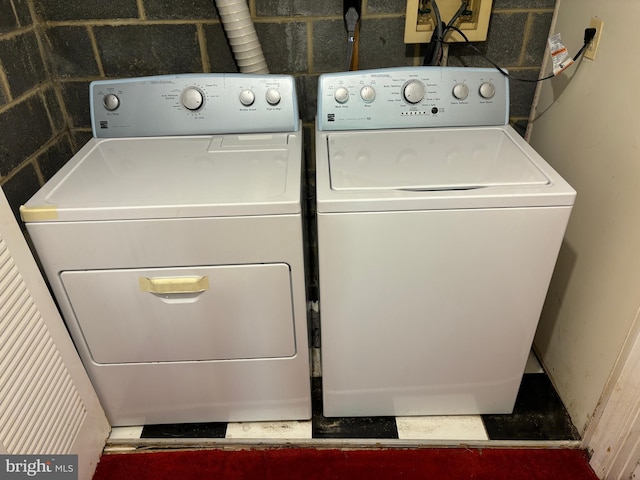 washroom with washing machine and clothes dryer