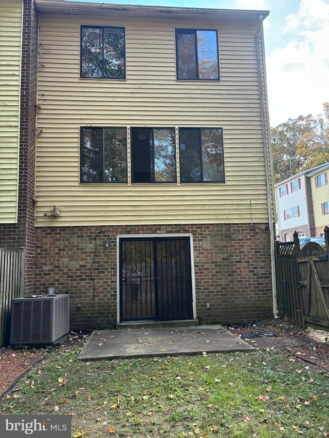 back of property featuring cooling unit and a patio