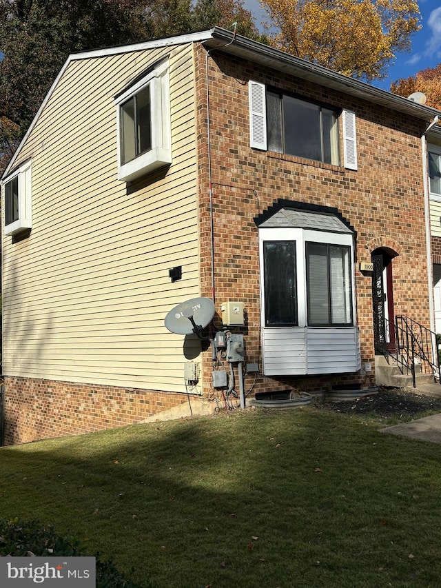 view of home's exterior with a yard