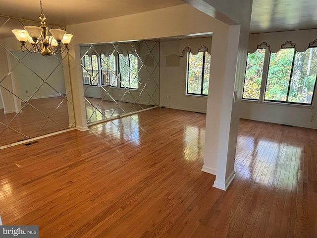 interior space with wood-type flooring and an inviting chandelier