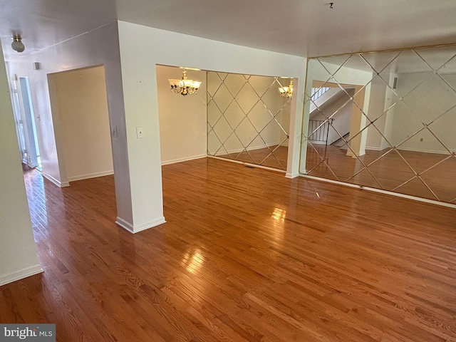 interior space featuring wood-type flooring and a notable chandelier