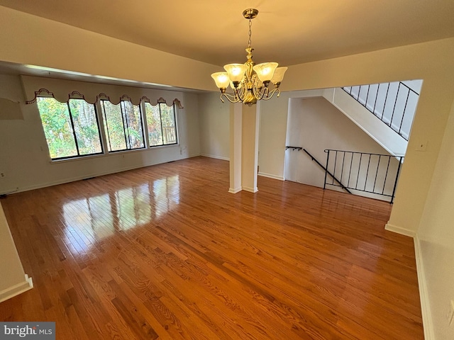 interior space featuring wood-type flooring and an inviting chandelier