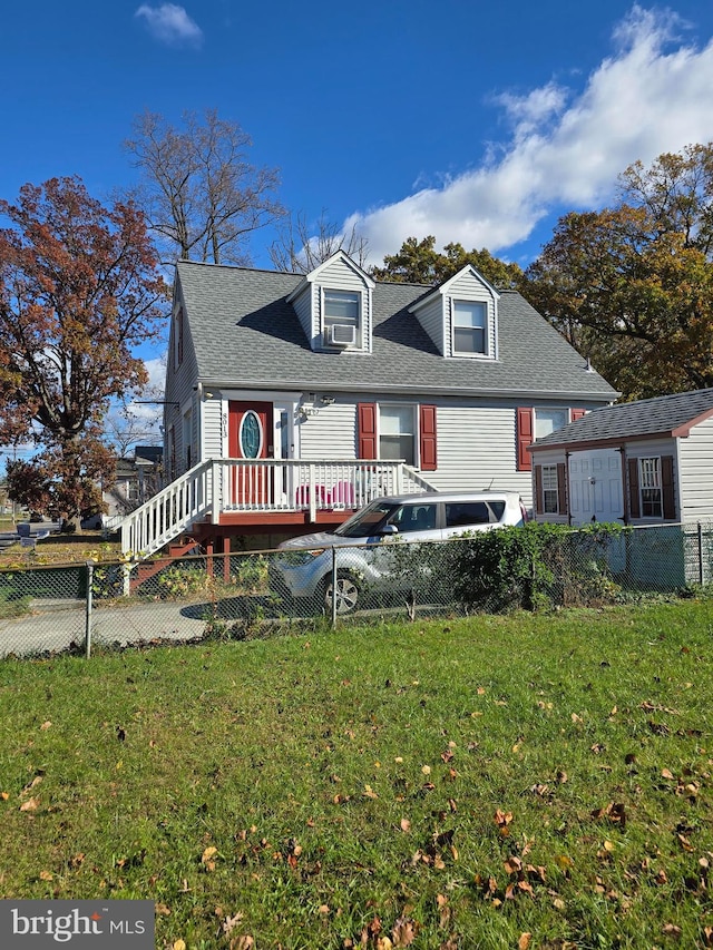 view of front facade with a front yard and a wooden deck