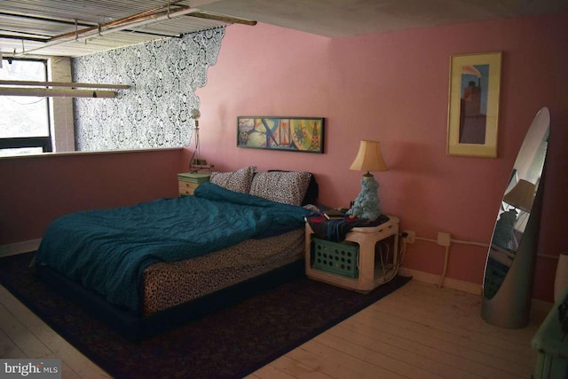 bedroom with wood-type flooring