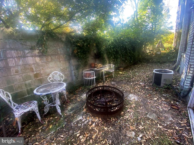 view of patio / terrace featuring a fire pit and cooling unit