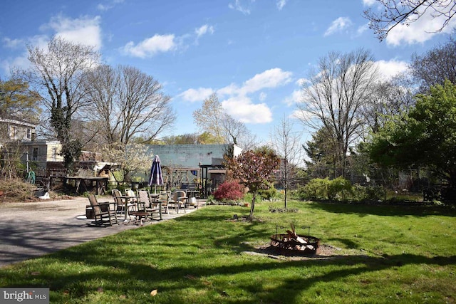 view of yard with a fire pit and a patio area