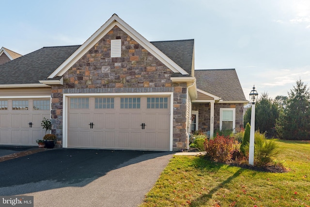 view of front of house featuring a garage and a front yard