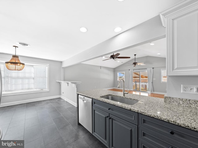 kitchen with white cabinets, light stone counters, sink, dishwasher, and lofted ceiling