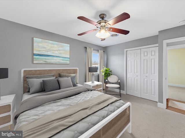 carpeted bedroom featuring ceiling fan and a closet