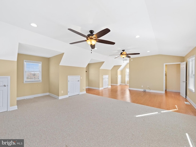 additional living space featuring ceiling fan, light hardwood / wood-style floors, and lofted ceiling