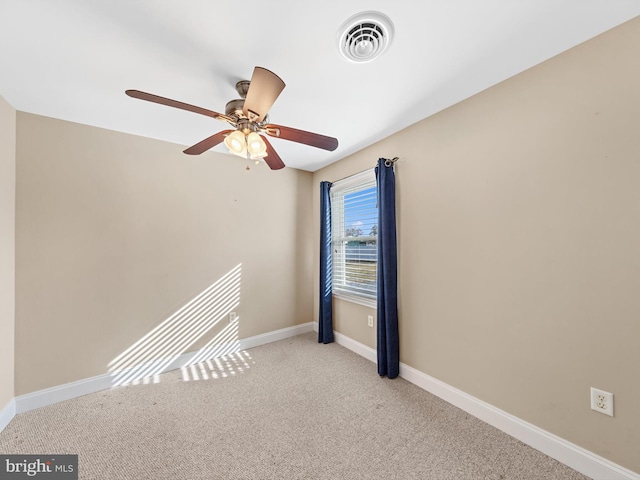 carpeted empty room featuring ceiling fan