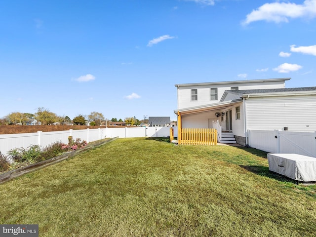 rear view of house featuring a yard