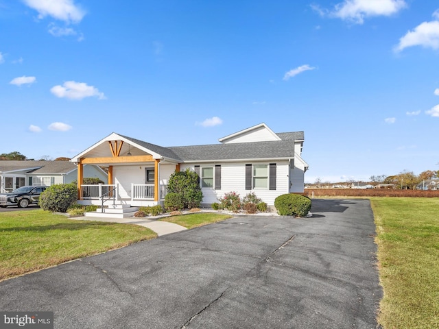 ranch-style home with covered porch and a front yard