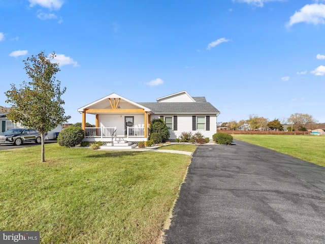 ranch-style home with a porch and a front lawn