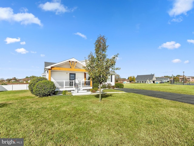 view of front of home featuring covered porch and a front yard