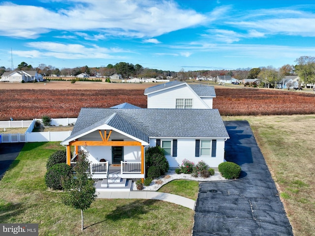 view of front of home featuring a front yard and a porch