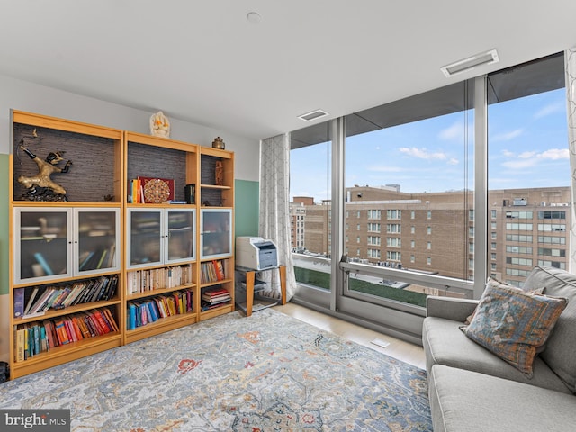 living area with wood-type flooring and floor to ceiling windows