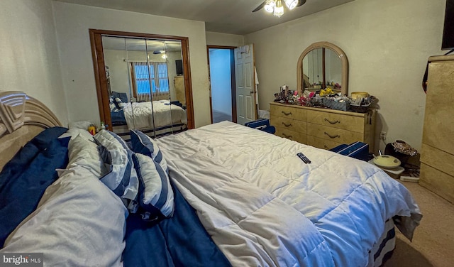 carpeted bedroom with ceiling fan and a closet