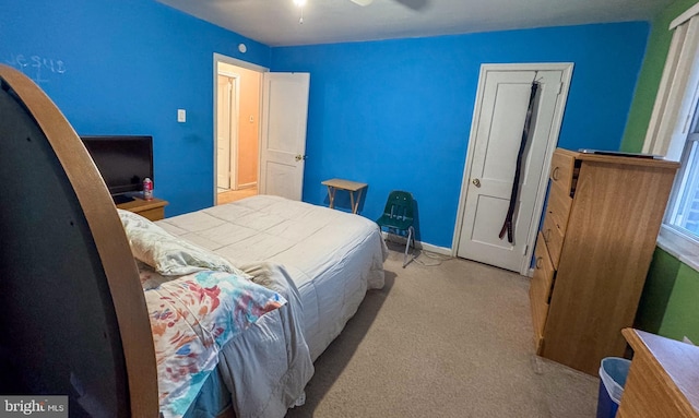 bedroom featuring light carpet and ceiling fan