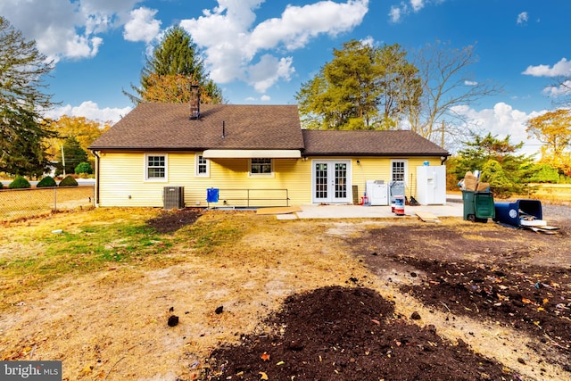 rear view of house featuring central AC unit, a patio, and french doors