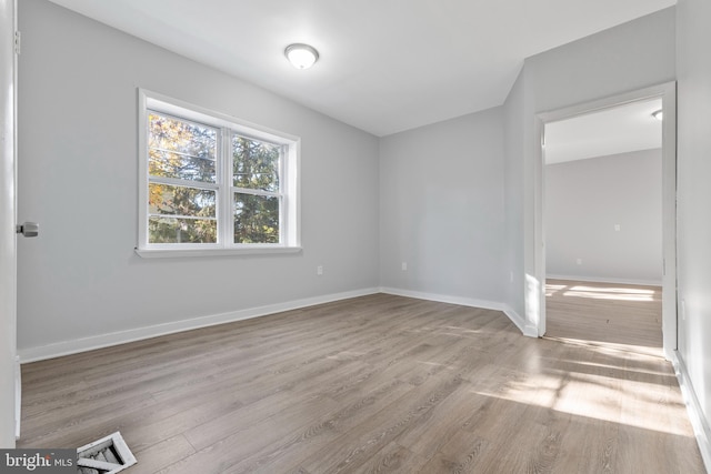 empty room with light hardwood / wood-style flooring