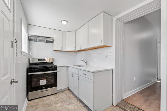 1826 Brunswick Ave, Lawrence Township, NJ 08648 - kitchen with stainless steel gas range, under cabinet range hood, a sink, light countertops, and white cabinetry