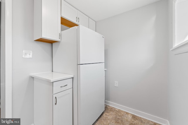 kitchen with white cabinets and white refrigerator