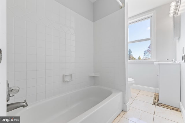 bathroom with tile patterned floors, tiled shower / bath combo, and toilet