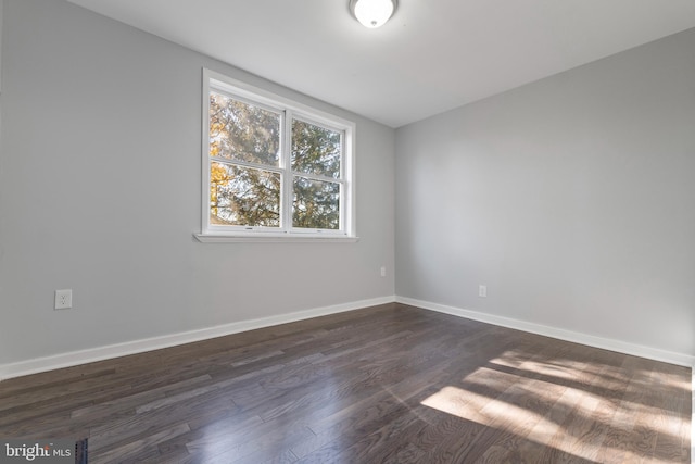 unfurnished room featuring dark hardwood / wood-style floors