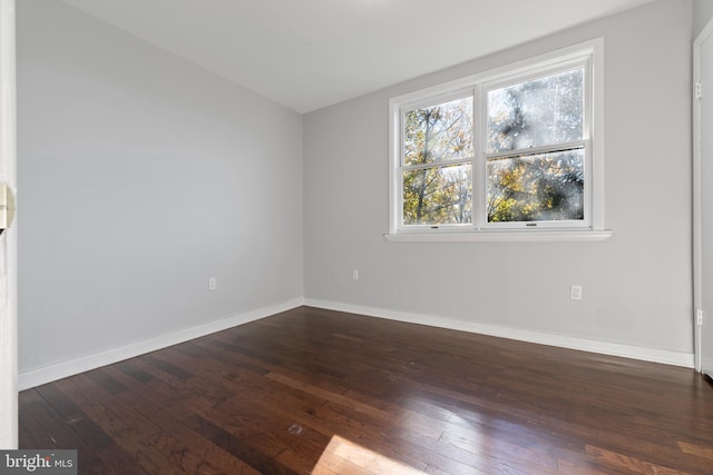 spare room featuring dark hardwood / wood-style floors