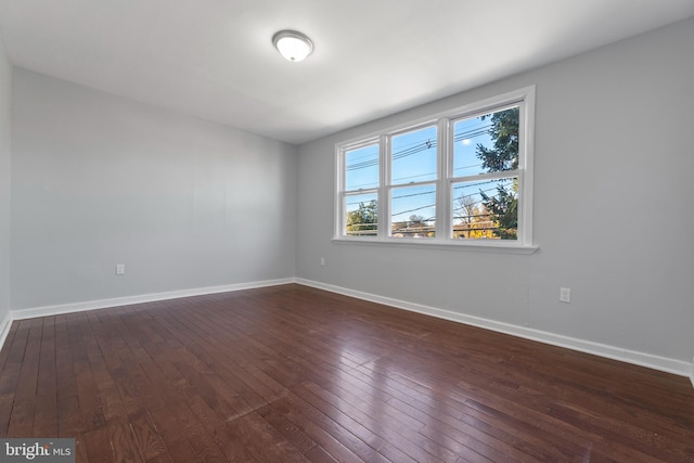 spare room with dark hardwood / wood-style flooring