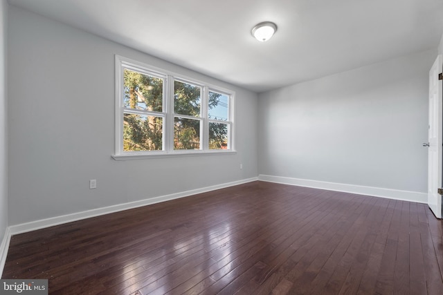 spare room with dark hardwood / wood-style flooring