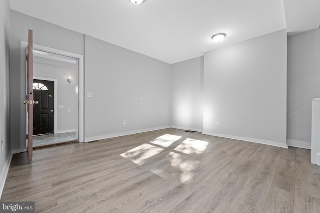 empty room with light hardwood / wood-style flooring