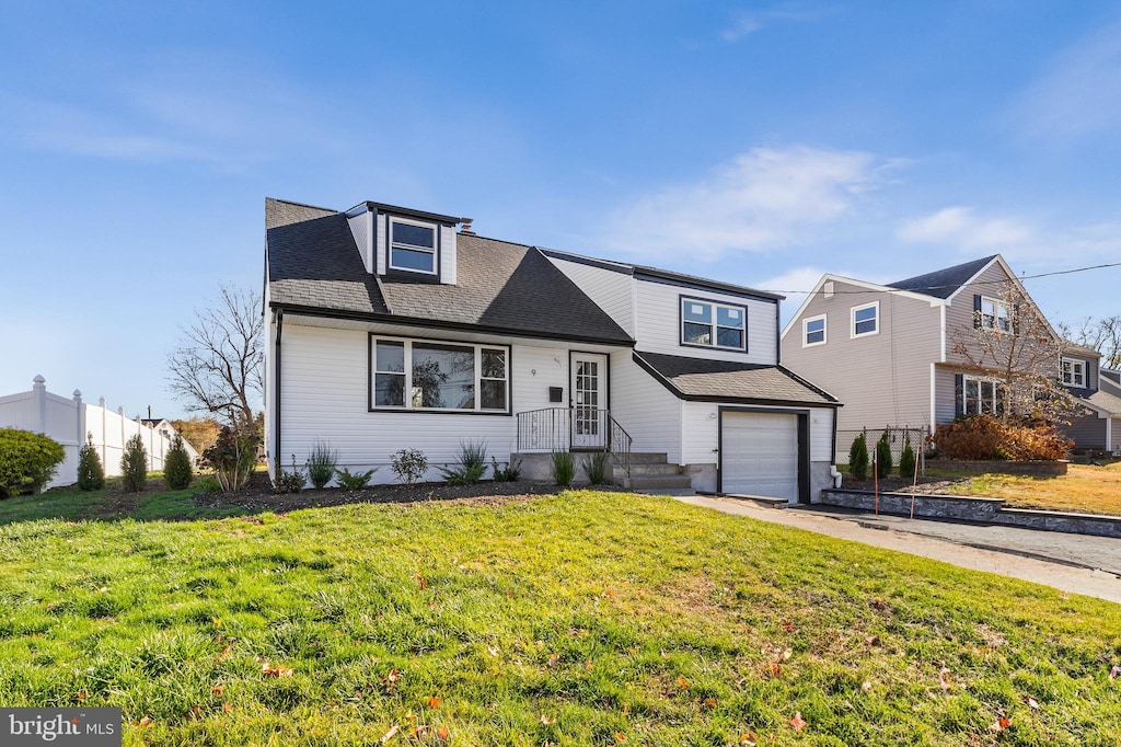 view of front facade with a front yard and a garage