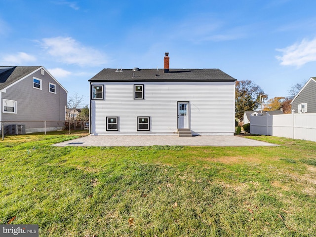 back of property featuring a lawn, a patio, and central AC unit