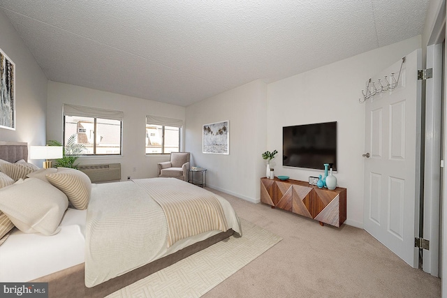 bedroom featuring a textured ceiling and light colored carpet