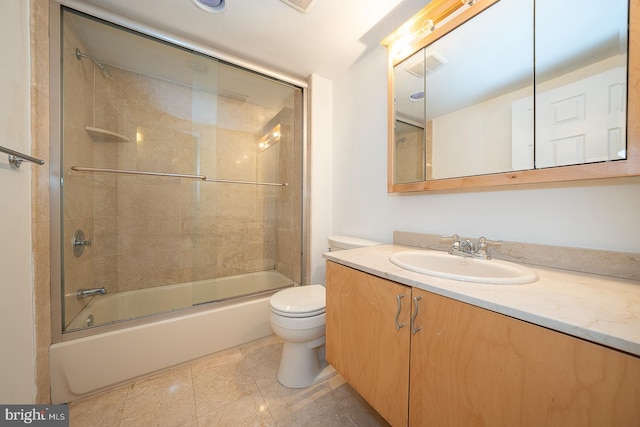 full bathroom with tile patterned floors, vanity, bath / shower combo with glass door, and toilet