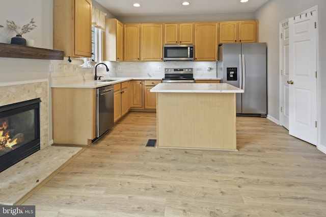 kitchen with recessed lighting, a sink, appliances with stainless steel finishes, and light countertops
