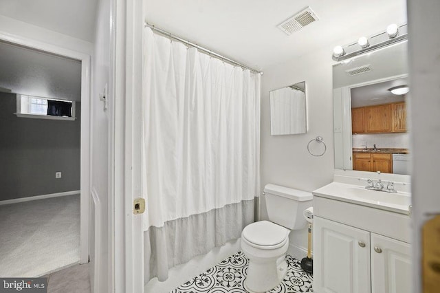 bathroom with tile patterned flooring, vanity, and toilet