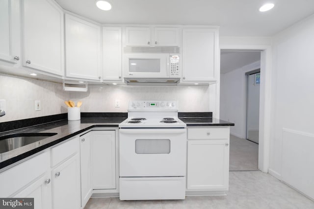 kitchen with sink, white cabinets, light tile patterned flooring, and white appliances