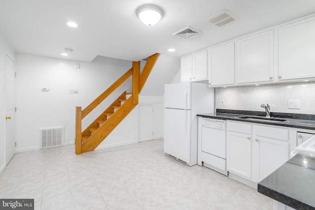 kitchen with decorative backsplash, sink, white cabinets, and white appliances