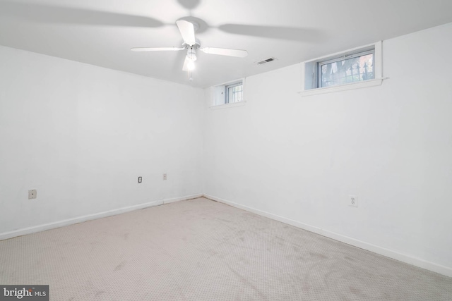 basement featuring light carpet