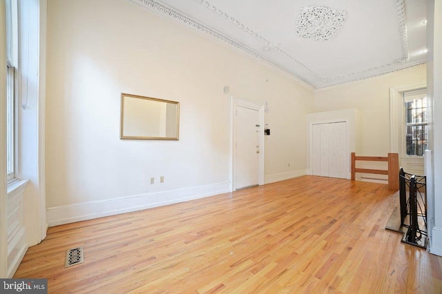 interior space featuring light wood-type flooring and crown molding