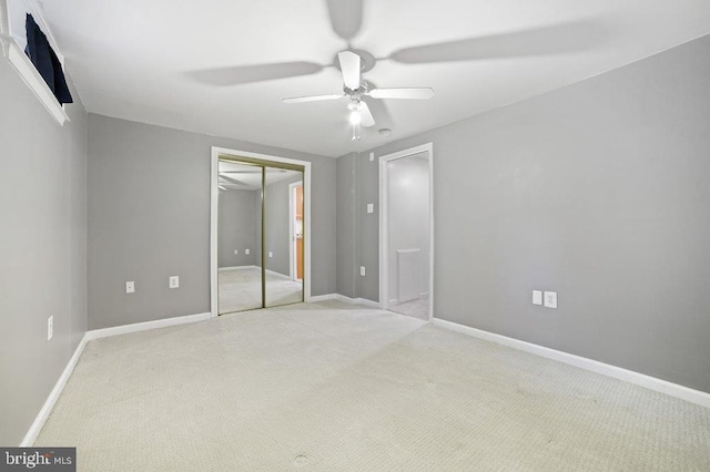 unfurnished bedroom with a closet, ceiling fan, and light colored carpet