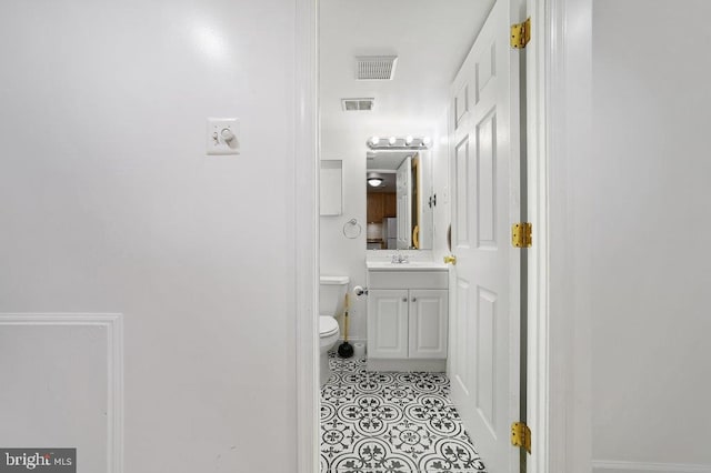 bathroom with vanity and toilet